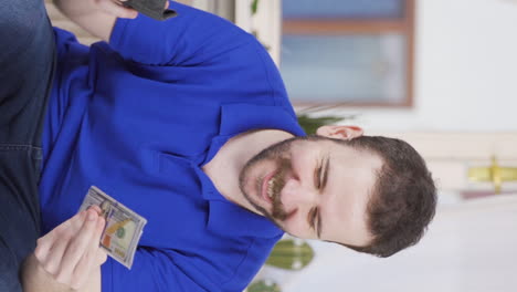 Vertical-video-of-The-rich-man-with-money-is-happy.